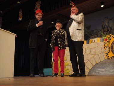 Drei verkleidete Personen auf einer Bühne stehend