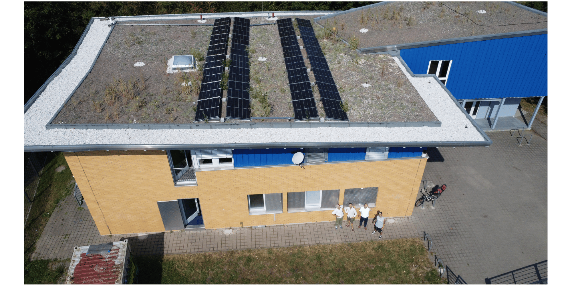 4 Männer stehend vor einem Gebäude