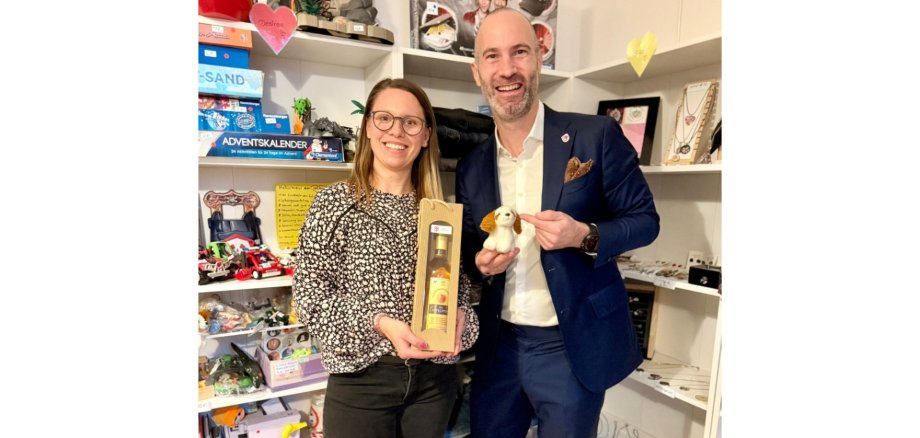 Eine Frau und ein Mann stehend in einem Ladengeschäft.