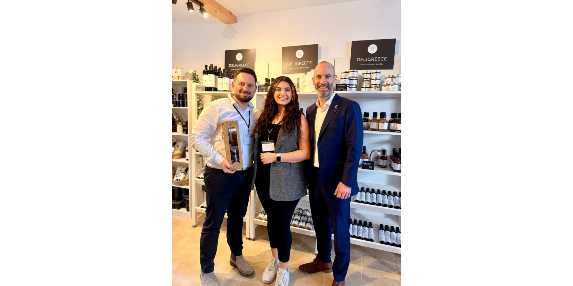 Zwei Männer und eine Frau stehend in einem Delikatessengeschäft