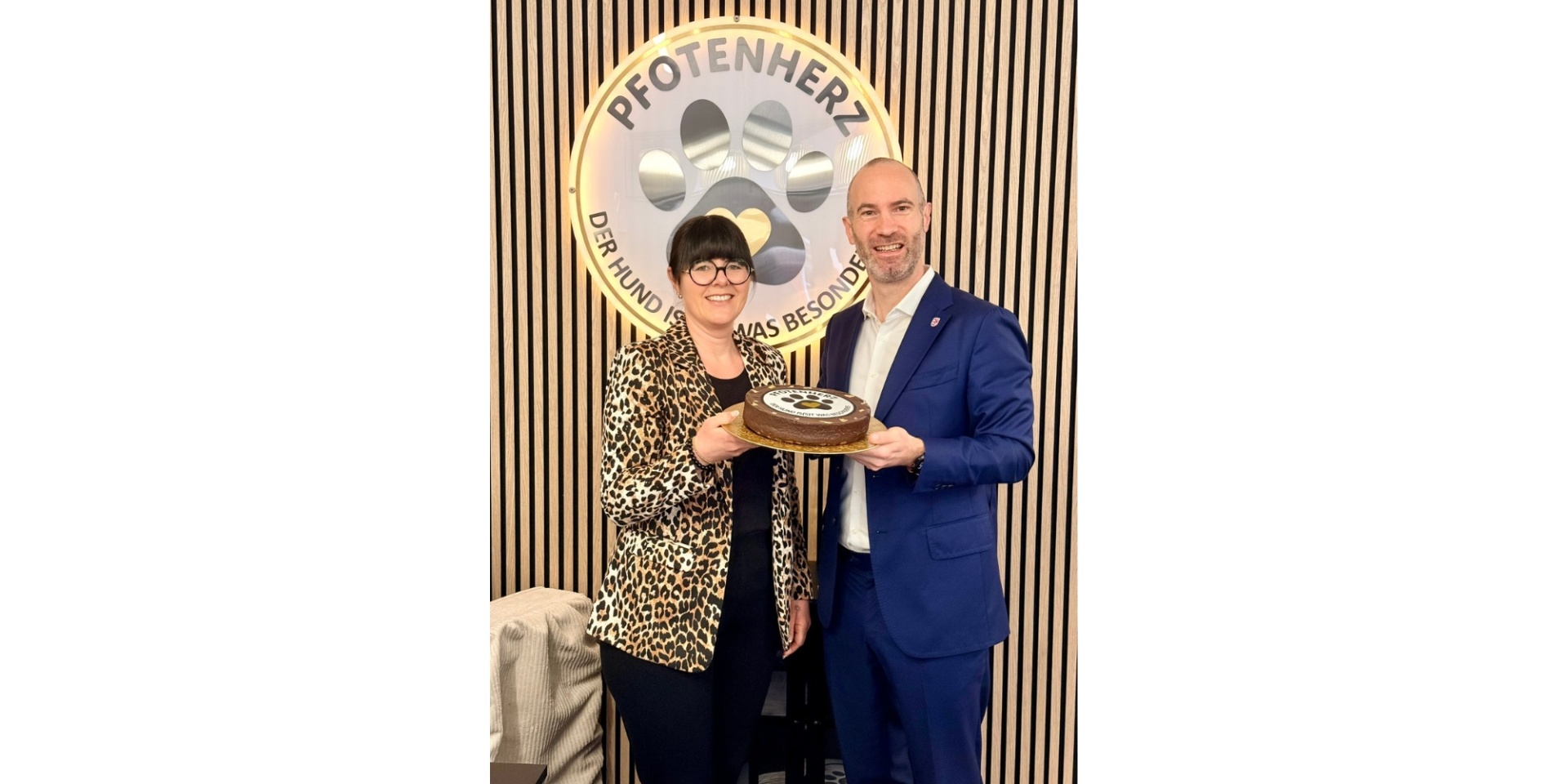 Ein Mann überreicht einer Frau  einen Kuchen