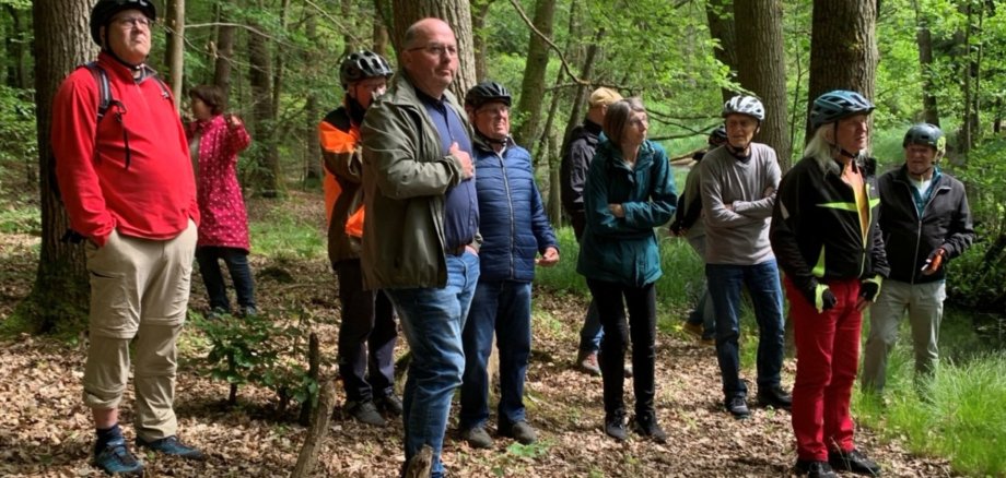 Mehrere Personen stehen in einem Wald