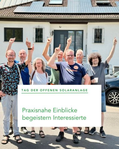 Mehrere Personen stehend nebeneinander vor einer Häuserfassade mit einem erhobenen Arm nach oben